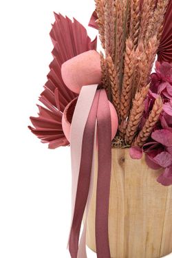 Centro de flores secas y preservadas en un macetero de madera