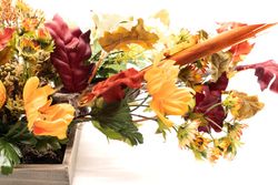 Centro de mesa alargado con flores artificiales en color naranja