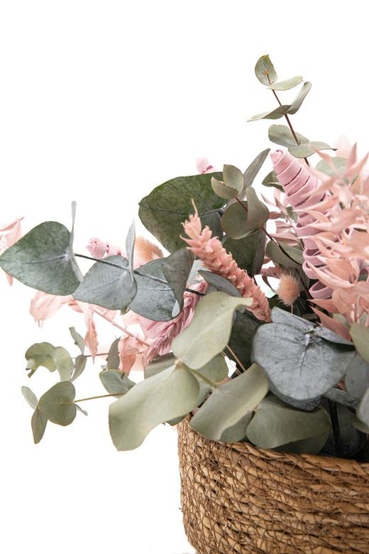 Cesta de paja natural con eucalipto preservado y flores preservadas en color rosa