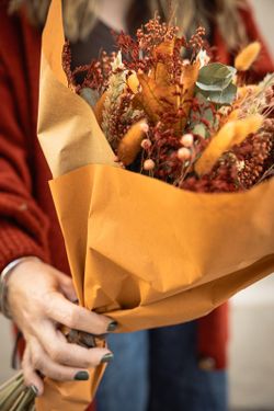 Elegante ramo de flores preservadas y secas con aire silvestre en colores naranjas y  marrones