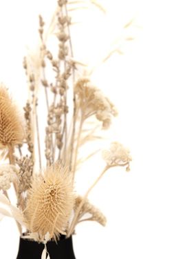 Minimalista jarrón de metal en color negro con arreglo floral de flores secas