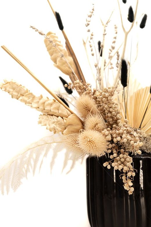 Moderno y sofisticado centro de mesa en base de cerámica negro y flores preservadas en tonos blanco y negro