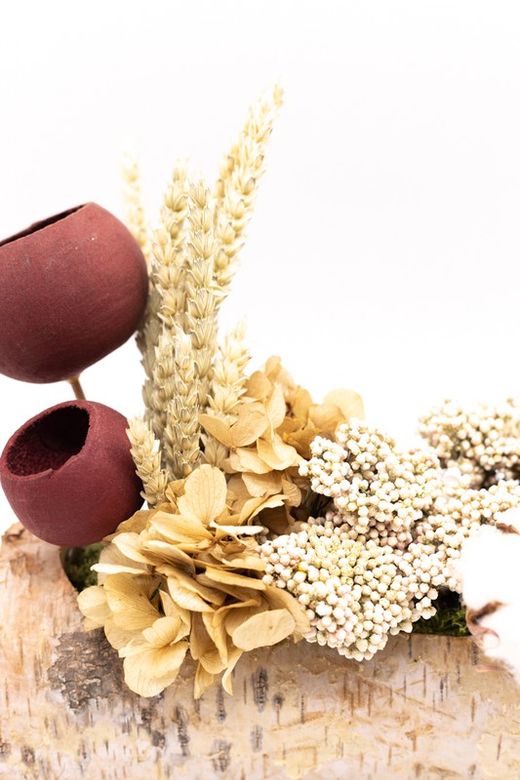 Tronco de madera natural con flores preservadas y flores secas