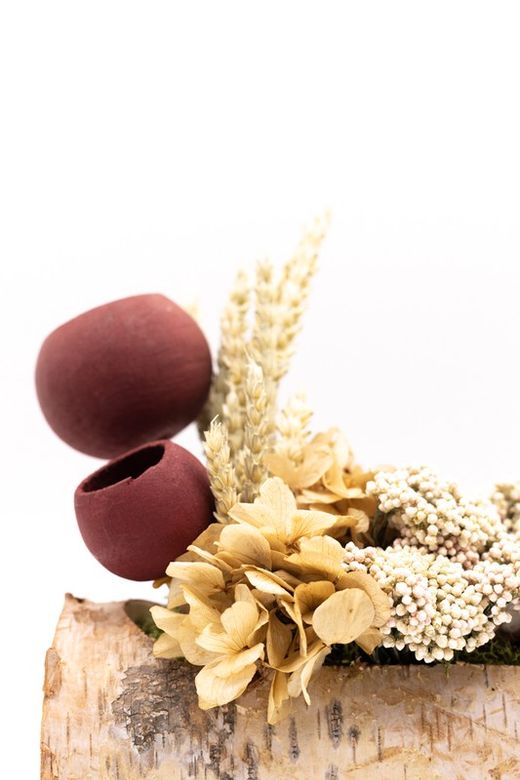 Tronco de madera natural con flores preservadas y flores secas